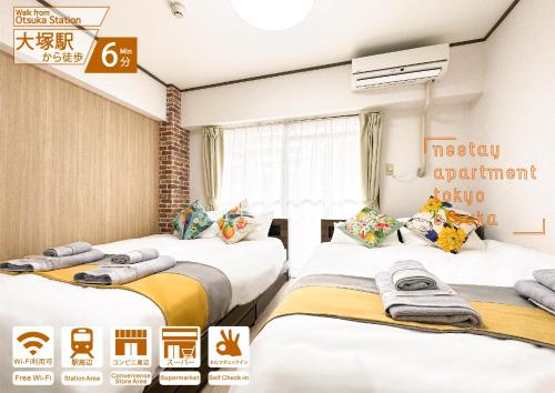 a hotel room with three beds and a window at nestay apartment tokyo otsuka in Tokyo