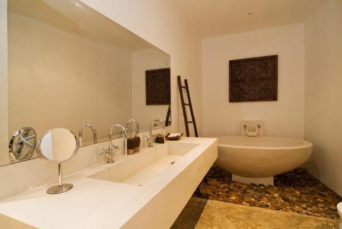 a white bathroom with a tub and a sink and a bath tub at Villa Kama in Rawai Beach