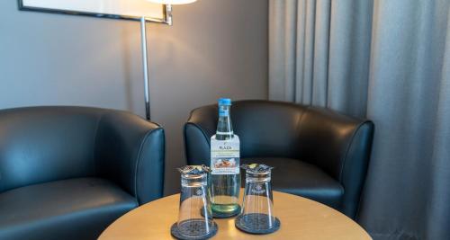 a bottle of wine sitting on top of a table at PLAZA Premium Köln in Cologne
