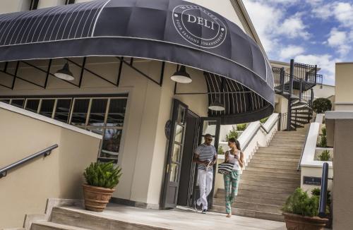 a man and a woman walking out of a building at Four Seasons Hotel The Westcliff in Johannesburg