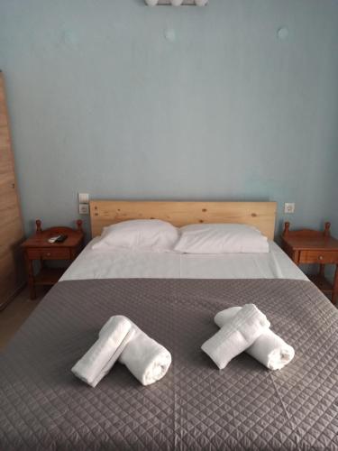 a bed with two towels on top of it at Arxontiko Studios in Limenas
