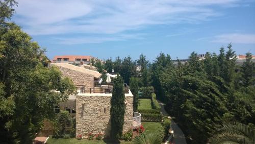 an aerial view of a stone house with trees at Rock House's Villa Melody in Plataniás