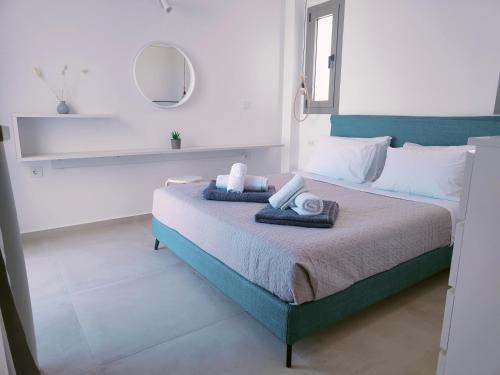a bedroom with a bed with towels on it at Alpha Villas in Gennadi