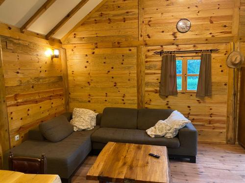 a living room with a couch and a table at Vikendica Milošević in Arandjelovac