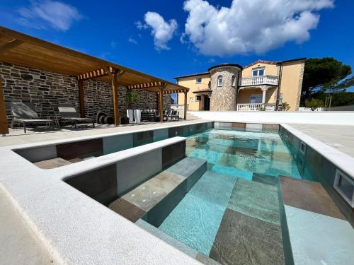 a swimming pool in the middle of a house at Olivea Luxury Suites in Fažana