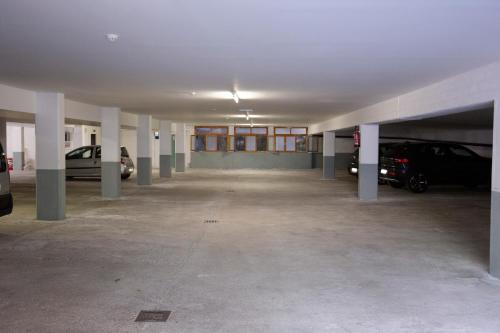 an empty parking garage with cars parked in it at Beohotel in San Lorenzo in Banale