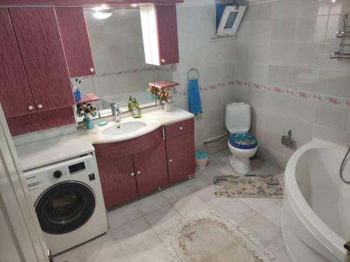 y baño con lavabo y lavadora. en Beylikdüzü bölgesinde ferah bir site içi konut, en Beylikduzu