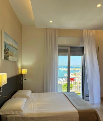 a bedroom with two beds and a view of the ocean at Il Vascello in Porto Cesareo