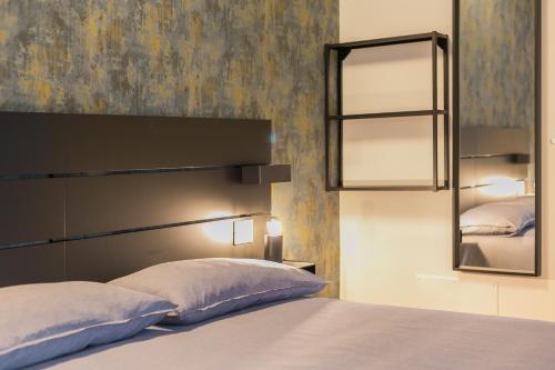 a bedroom with a large bed and a mirror at La Maddalena Suite & Rooms in Bitonto