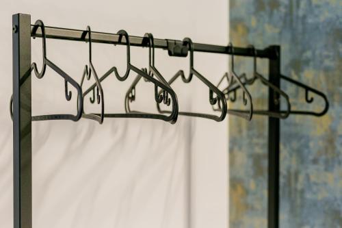 a group of hangers with a shower curtain at La Maddalena Suite & Rooms in Bitonto