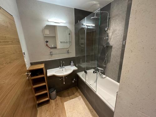 a bathroom with a sink and a shower and a bath tub at Top 1 Gartenwohnung in Kitzbühel