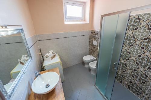 a bathroom with a sink and a toilet at Palazzo Ciravegna in Alba