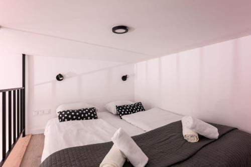 a bedroom with two beds with towels on them at DIETLA 99 APARTMENTS - IDEAL LOCATION - in the heart of Krakow in Kraków
