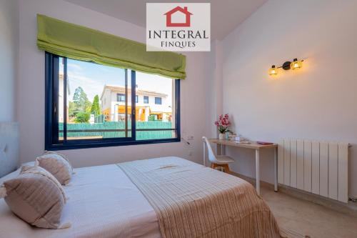 a bedroom with a bed and a window and a desk at Casa Pool TimeOut in Palamós