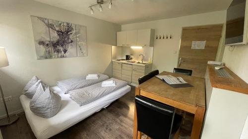 a small room with a bed and a desk at Haus Alpenglühen in Ehrwald