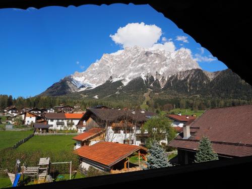 a view of a mountain from a village with houses at Haus Alpenglühen in Ehrwald