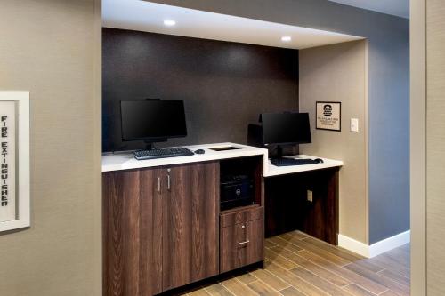 a room with two computer monitors on top of a counter at Residence Inn Fairfax Merrifield in Merrifield