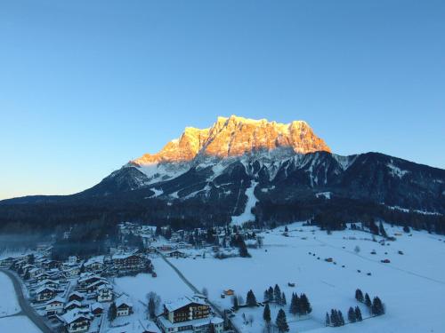 a mountain with the sun shining on it in the snow at Haus Alpenglühen in Ehrwald