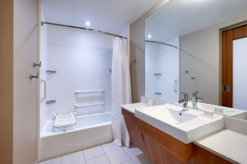 a bathroom with a sink and a tub and a shower at SpringHill Suites by Marriott Salt Lake City Draper in Draper