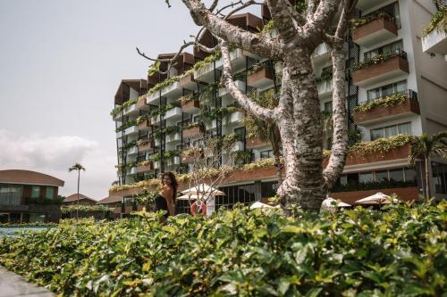 a woman standing in front of a building at Bellerive Hoi An Resort and Spa in Hoi An