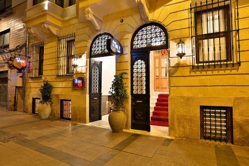 a building with a black door and two windows at Taxim Lounge Hotel Special Category in Istanbul