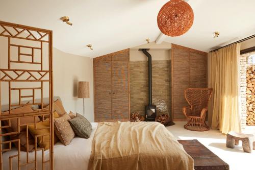 a bedroom with a large bed and a fireplace at Maisons 322 - La Lumineuse in Le Bois-Plage-en-Ré