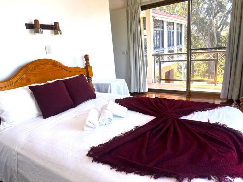 a bedroom with a large bed with towels on it at Ocean View 3 bedroom entire house central of Caloundra in Caloundra West
