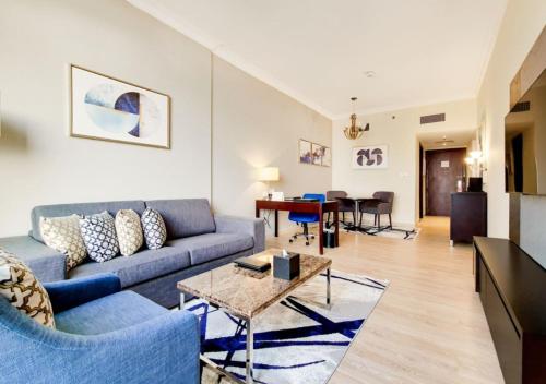 a living room with a couch and a table at Two Seasons Hotel & Apartments in Dubai