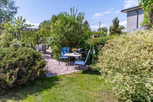 a patio with chairs and a table in a garden at Fantastic 170m2 Villa with a big garden in Pärnu