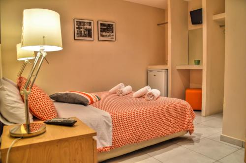 a bedroom with a bed with two stuffed animals on it at Iro Suites in Andros