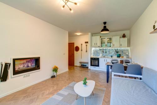 a living room with a couch and a table at Villa Kometa Pamporovo Cozy 1-BD Flat by Flat Mаnager in Pamporovo