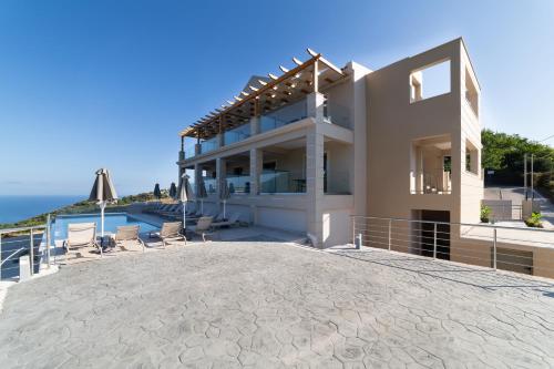 a villa with a view of the ocean at Sky View Suites Kefalonia in Vóvikes