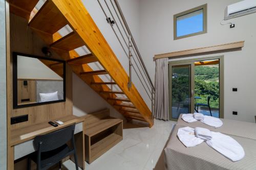 a room with two beds and a staircase at Sky View Suites Kefalonia in Vóvikes