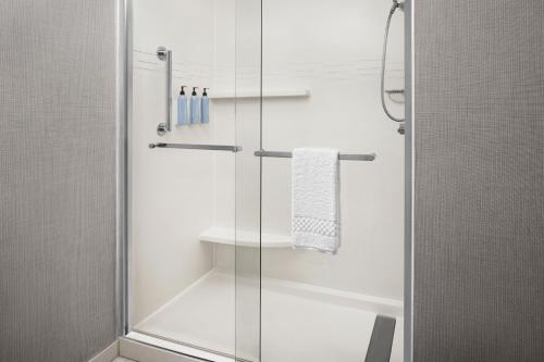 a shower with a glass door in a bathroom at Residence Inn Indianapolis Northwest in Indianapolis