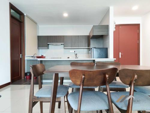 a kitchen with a table and chairs in a room at Bay Resort by Evernent in Miri