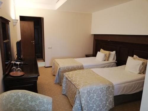 Giường trong phòng chung tại Apartament 804- Etaj 8 in incinta Alpin Resort - gazda privata