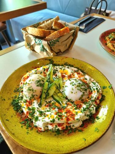 a plate of food with eggs and bread on a table at Apartamenty BalticON Nadmorskie Tarasy in Kołobrzeg