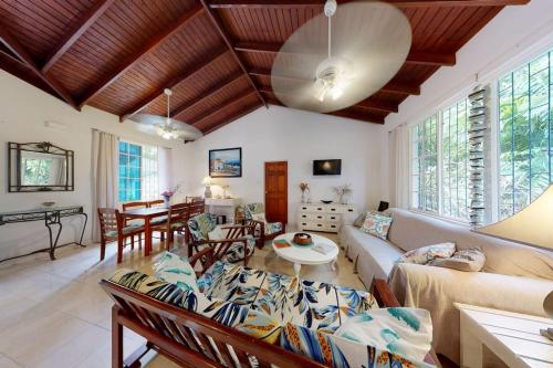a living room with a couch and a table at Kismet Garden Cottages - Dover Beach in Christ Church