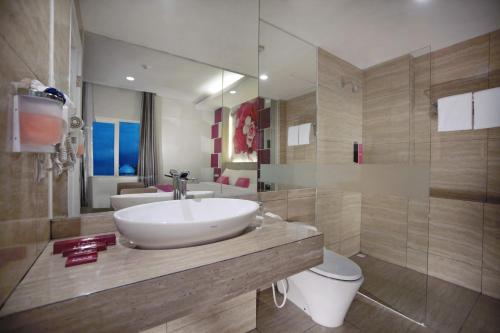 a bathroom with a sink and a toilet at favehotel Langko Mataram - Lombok in Mataram