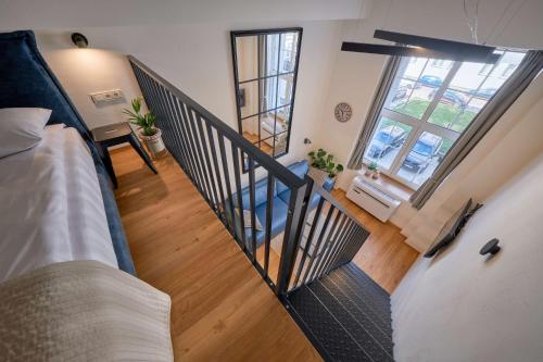 einen Blick über ein Zimmer mit einem Bett und einer Treppe in der Unterkunft Queen Barbora Central Lofts in Kaunas