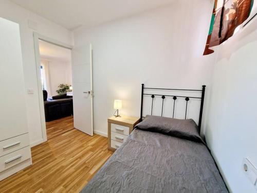 a bedroom with a bed and a couch in a room at Ground floor Apt in La Cala in Mijas Costa