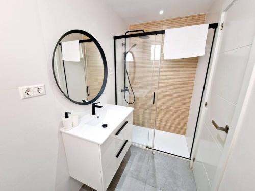 a bathroom with a white sink and a mirror at Ground floor Apt in La Cala in Mijas Costa
