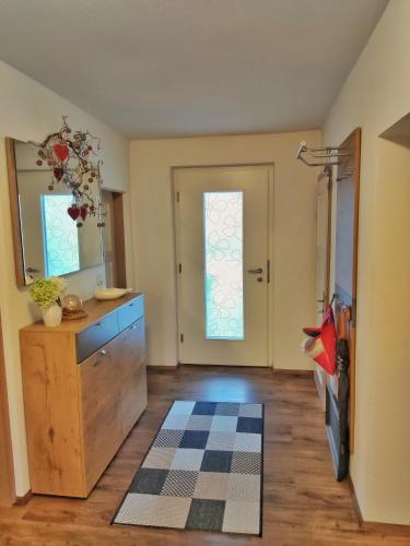 a room with a dresser and a mirror and a door at Unterm Nussbaum 2 in Rassing