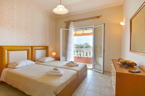 a hotel room with two beds and a window at Tranquil Corfu Villa - 3 Bedrooms - Villa Chrinos - Gated Pool - Agios Georgios Pagon in Agios Georgios Pagon