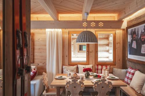 a wooden dining room with a table and chairs at Osada Gąsienica Centrum Zakopane in Zakopane