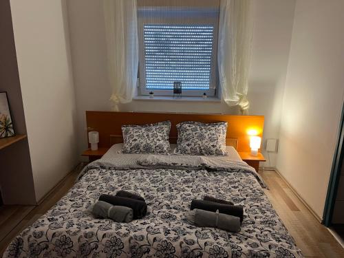 a bedroom with a large bed with two pillows on it at Szarkafészek in Keszthely