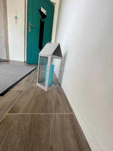 a glass box on the floor in front of a door at Szarkafészek in Keszthely