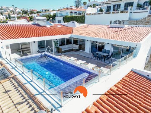 a villa with a swimming pool and a house at #078 Prestige Villa by Home Holidays in Páteo