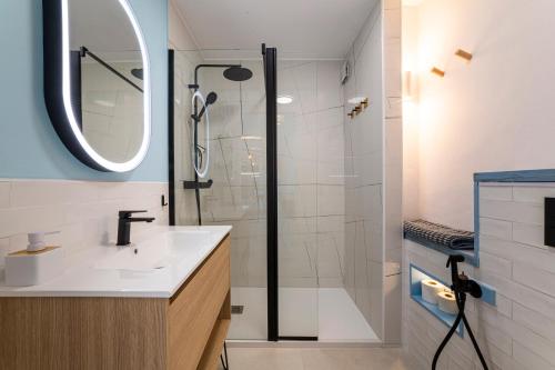 a bathroom with a shower and a sink and a mirror at Los acantilados in Almería
