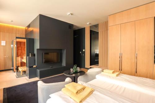 a bedroom with a large bed and a tv at Ilonn Boutique Limanowskiego in Poznań
